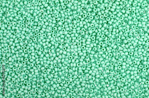 Green glass beads background - closeup beads texture