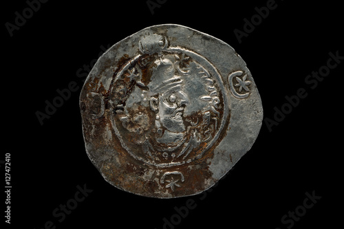 Ancient silver Sassanian coin isolated on black
