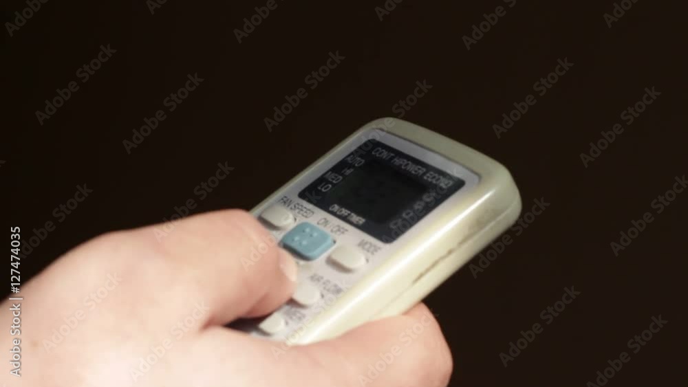 Conditioner remote control in man's hands Conditioner remote control in man's hands