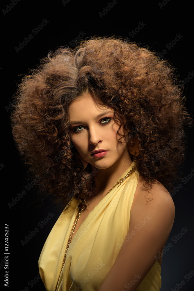 Brunette girl with a curly hairstyle, modern make-up and carnivore look Brunette girl with a curly hairstyle, modern make-up and carnivore look
