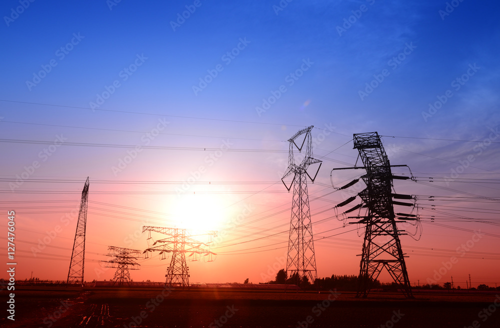 Fototapeta premium High voltage towers under the setting sun