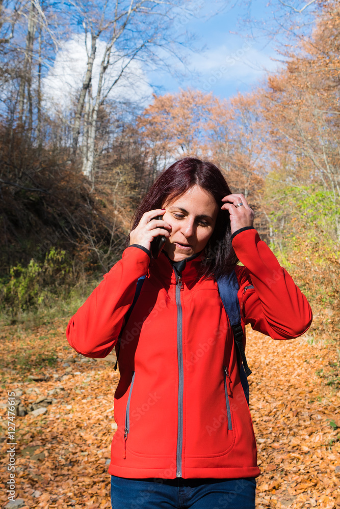 Woman using her mobile phone while hiking