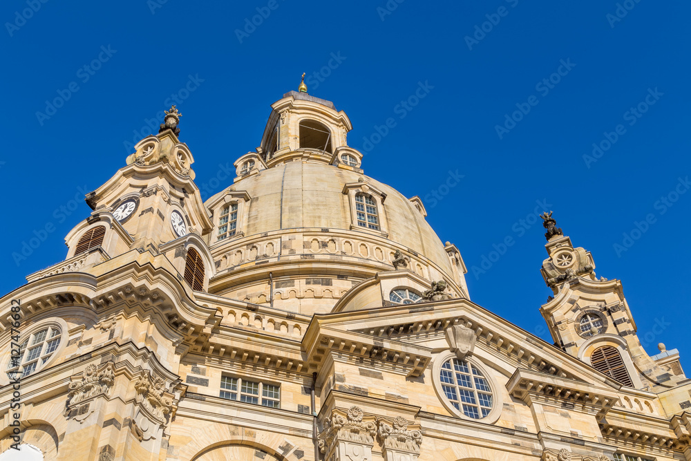 Famous Frauenkirche in the city center of Dresden, Germany in the morning sun with blue sky above.