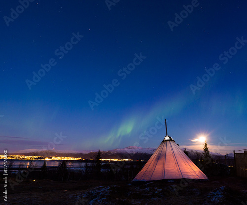 Traditional Sami reindeer-skin tents  lappish yurts  in Troms region of Norway .The polar lights in Norway .