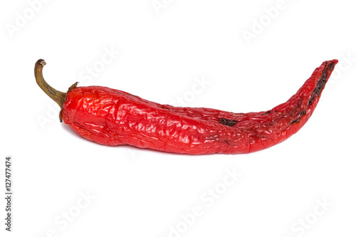 Rotten chili pepper isolated on white background. The natural color and texture. Spoiled vegetables.