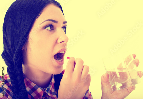 Woman taking pill photo