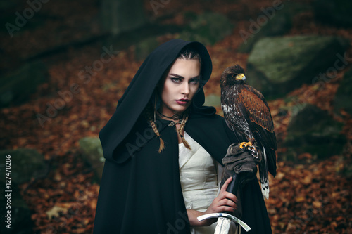 Female warrior with sword and hawk
