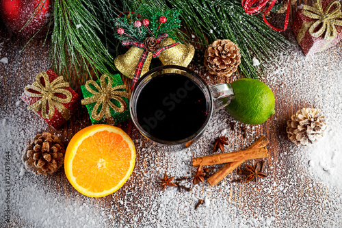 Hot Mulled wine with cinnamon sticks, orange, lime. christmas concept.