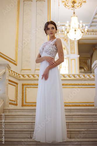 beautiful young woman bride in luxury wedding dress in interior