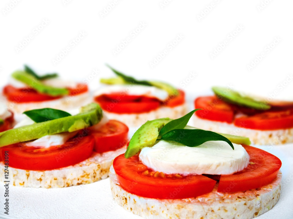 Healthy food - sandwiches, rice crackers with tomato, avocado and mozzarella cheese