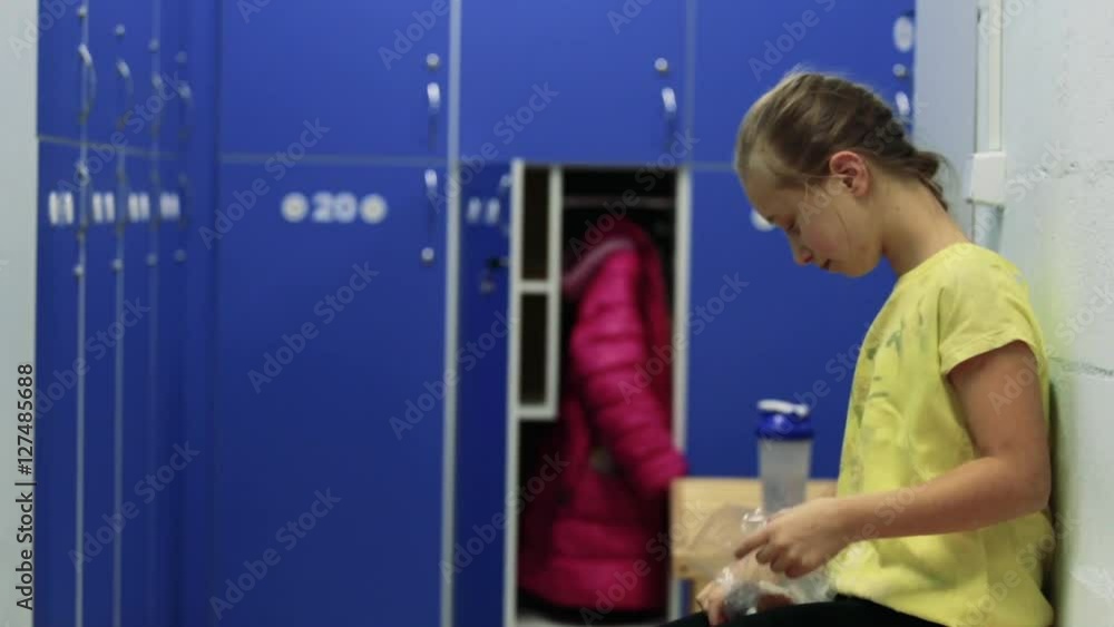 Girl eats in the locker room after the workout. concept, fitness Girl eats in the locker room after the workout. concept, fitness