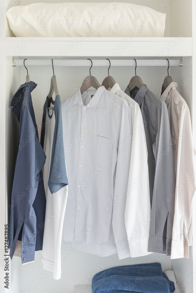 clothes hanging on rail in modern white wardrobe clothes hanging on rail in modern white wardrobe