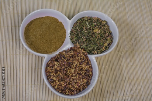 Assorted spices in white bowls