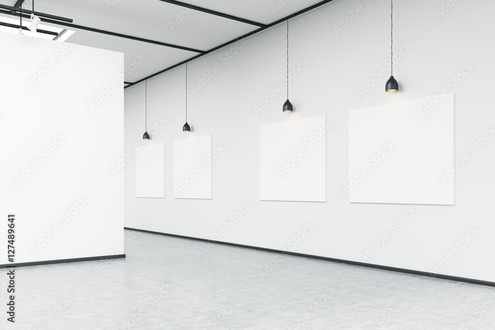 Corner of art gallery with large white wall and pictures Stock