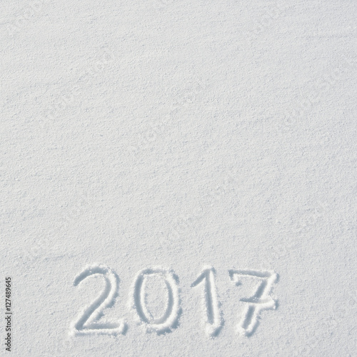 2017 numbers handwritten on flat snow surface. Empty space for copy, text, lettering. New year holiday postcard, greeting card template.