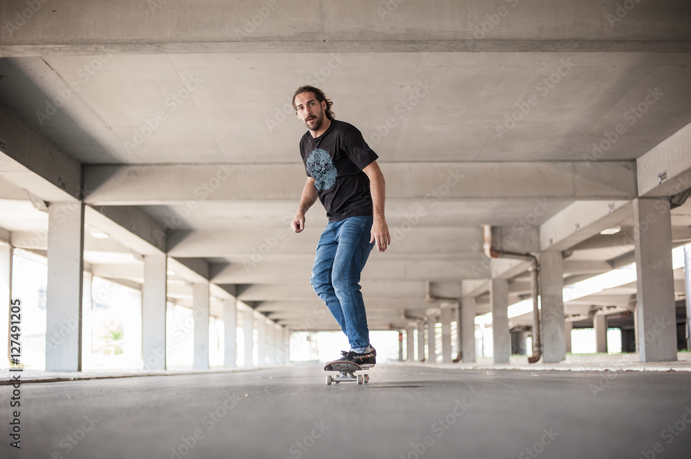 Professional skateboarder in underground passage Professional skateboarder in underground passage