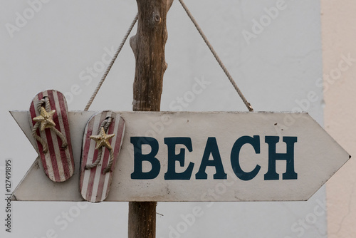 Arrow sign indicates the way to the beach in Ecuador photo