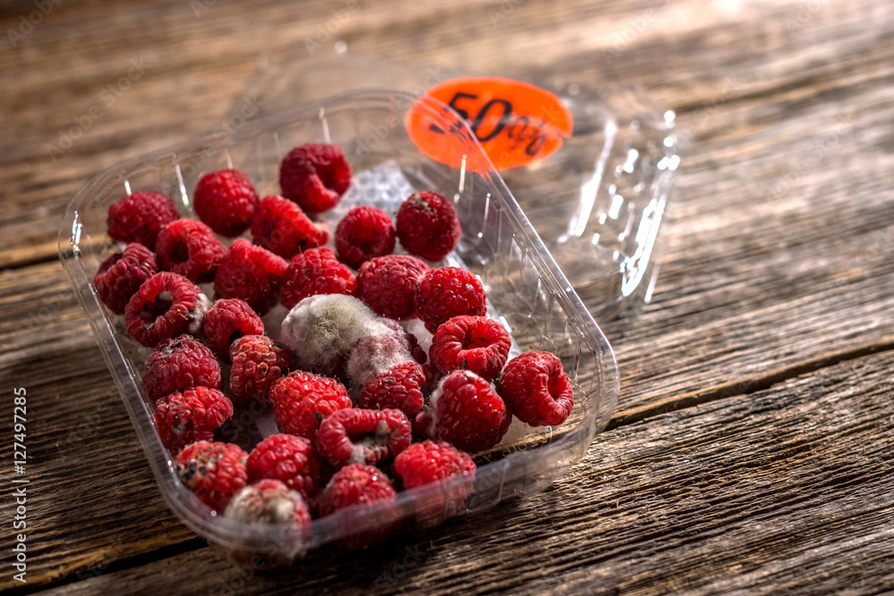 Raspberry in a plastic box bought on sale Stock Photo | Adobe Stock