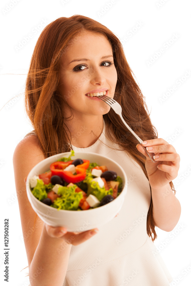 healthy eating - woman eats a bowl of greek salad isolated over healthy eating - woman eats a bowl of greek salad isolated over