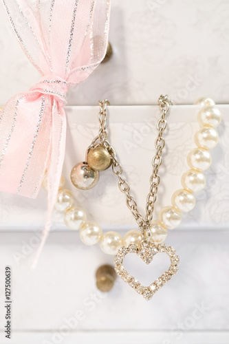 necklace and bracelet, cute lady accessories, selective focus on the heart pendant. Sweet romantic and valentine concept.