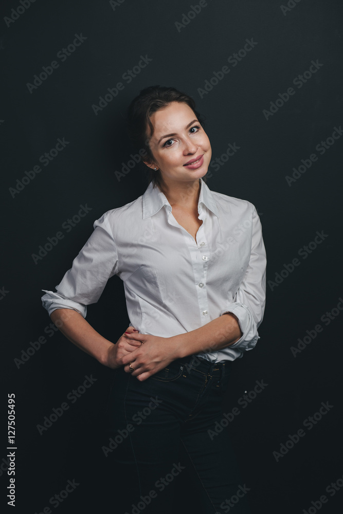 Young Brunette woman posing against black Young Brunette woman posing against black