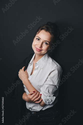 Young Brunette woman posing against black
