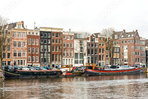 Beautiful view of Amsterdam canals with bridge and typical dutch