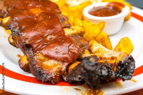 Grilled steak - Grilled meat ribs on the plate with hot sauce