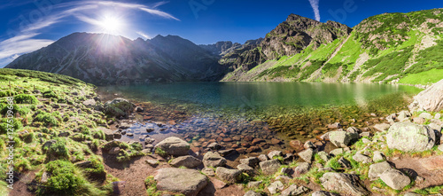 Panorama of sunrise at Czarny Staw Gasienicowy in Polish Mountains