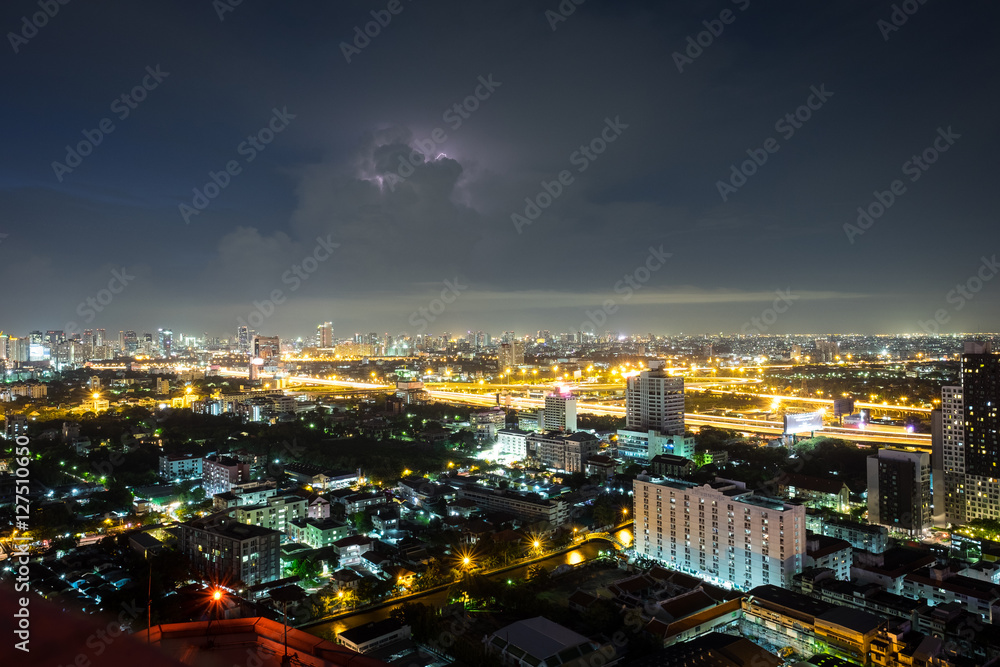 Bangkok city scape in the night with cloudy and a little  lightning