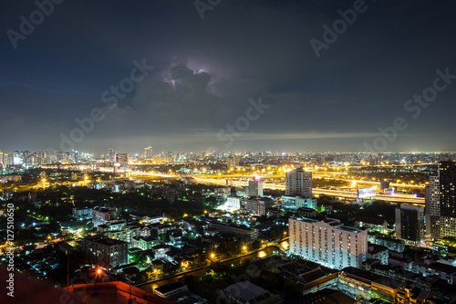 Bangkok city scape in the night with cloudy and a little lightning