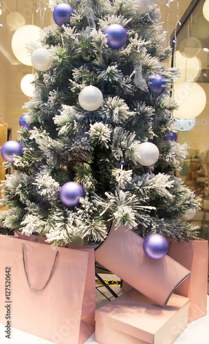 Christmas bags with gifts near the Christmas tree silver beautiful purple  beautiful and fluffy Christmas tree