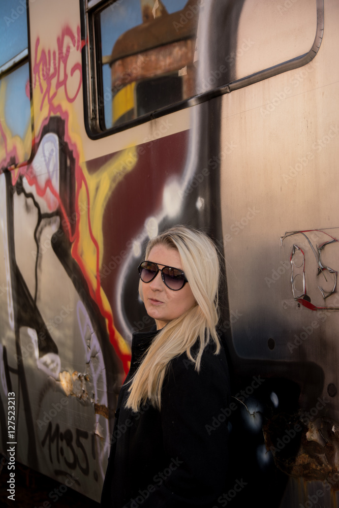 Fototapeta premium Young sexy girl with train and grafity