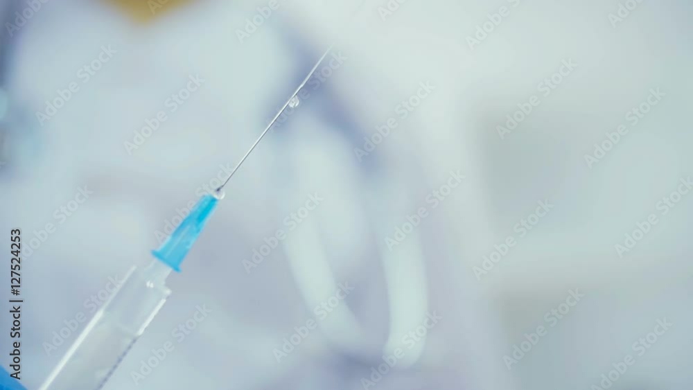 Close up of a syringe with medicine from which let out the air Close up of a syringe with medicine from which let out the air