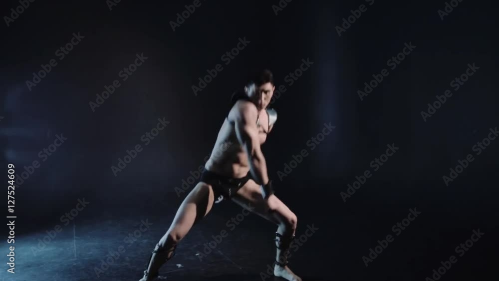Sexy muscular man dance on dark background. Beautiful body. Sex and passion. Copy space text. Professional color correction. Sexy muscular man dance on dark background. Beautiful body. Sex and passion. Copy space text. Professional color correction.
