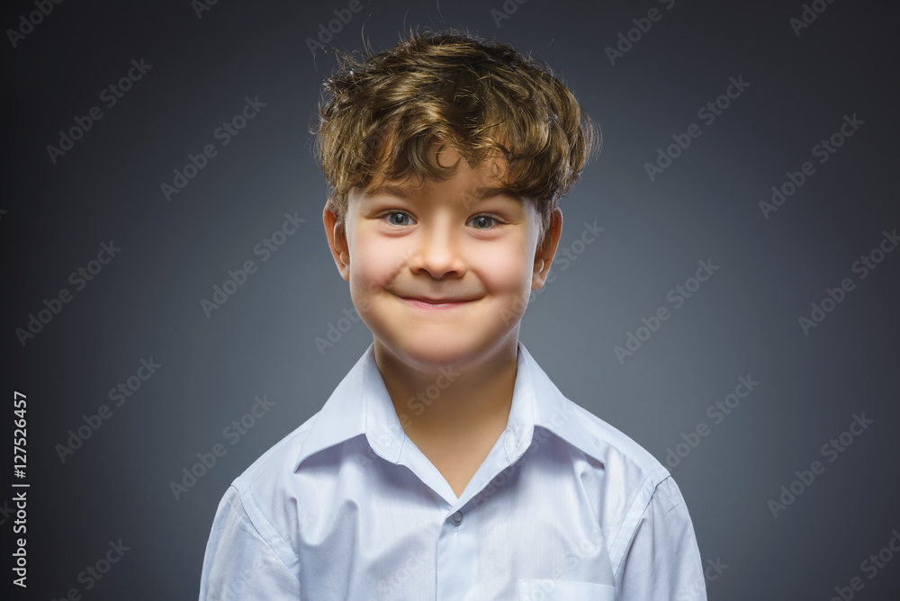 Happy child. Closeup Portrait of handsome boy smiling isolated on grey background Happy child. Closeup Portrait of handsome boy smiling isolated on grey background