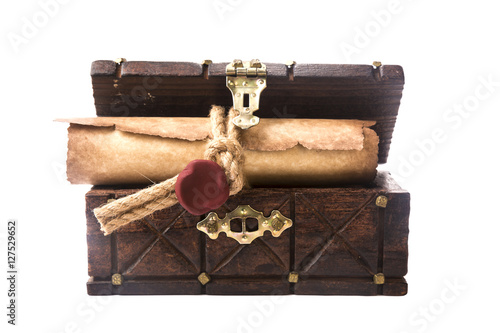 The ancient chest and a scroll with a seal isolated on white