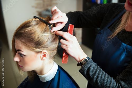 Hairdresser prepares for work with young woman.