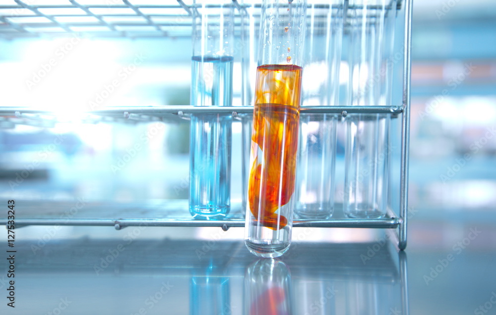 test tubes with orange solution in metal rack in lab science test tubes with orange solution in metal rack in lab science