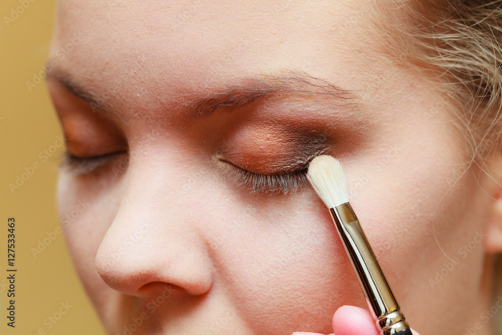 Close up woman getting make up, eyeshadow