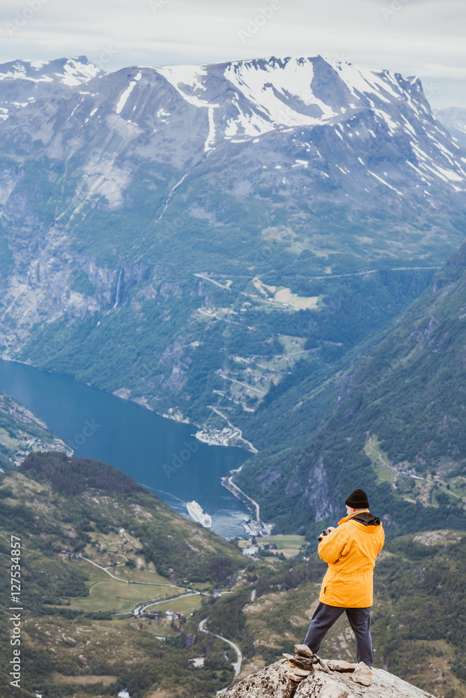 Tourist taking photo from Dalsnibba viewpoint Norway Tourist taking photo from Dalsnibba viewpoint Norway