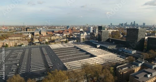 Aerial push in view over Euston station with the skyline of the City of London in the background photo