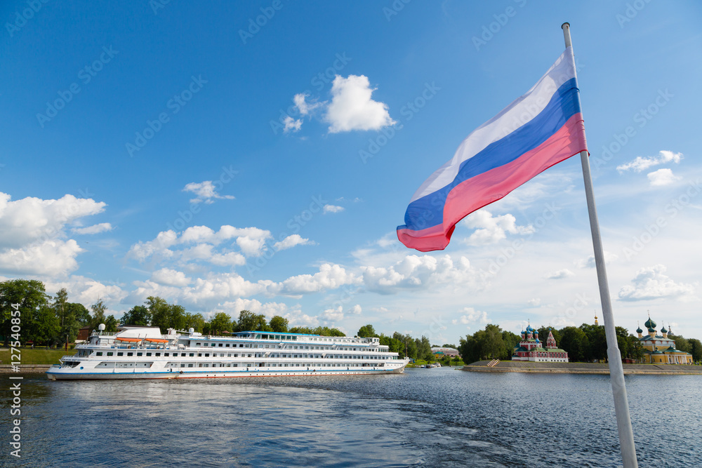 Fototapeta premium Russian flag on the background of the town of Uglich