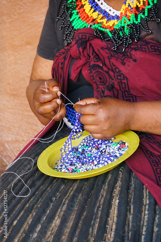 African woman making souvenirs for sell at Lesedi Cultural Villa
