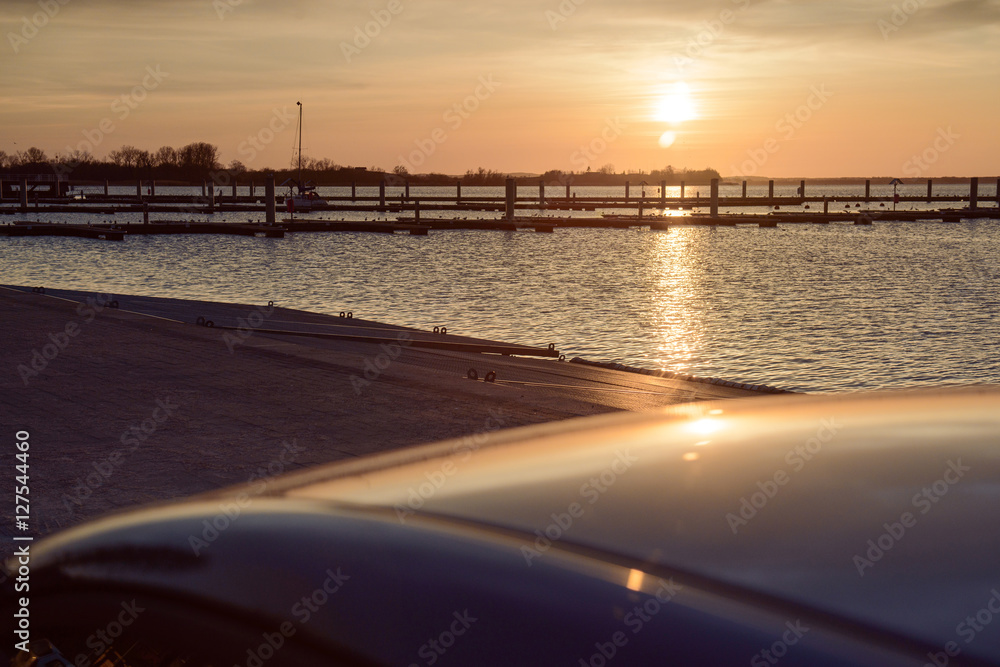 Yacht port over orange sunset