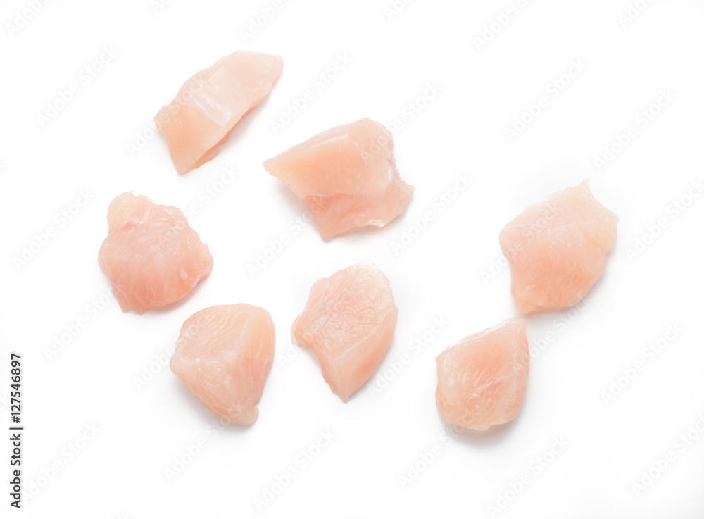 Raw chicken fillet. Small pieces of meat isolated on white. Top view. Raw chicken fillet. Small pieces of meat isolated on white. Top view.