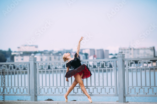 ballerina posing on a background of the lake