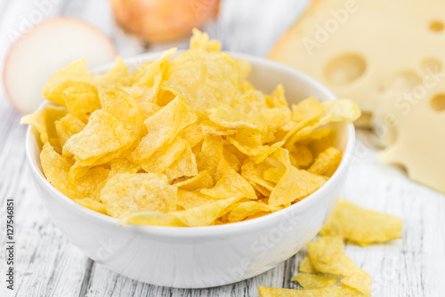 Cheese and Onion Potato Chips (selective focus) on vintage woode