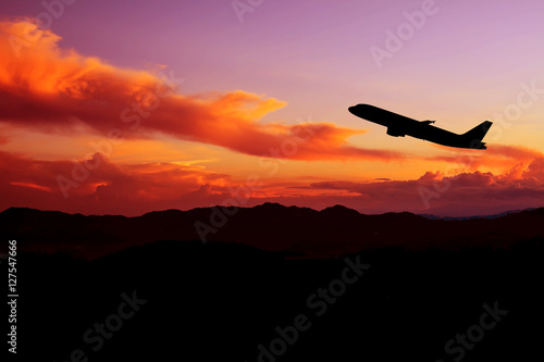 Silhouette of an airplane at sunset. © Bluesky60
