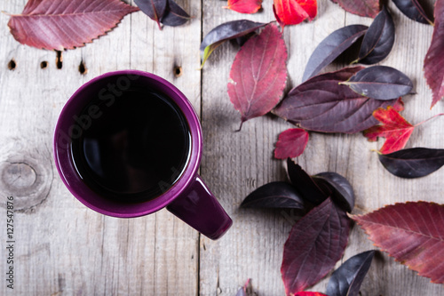 Quadro em tela Cup of coffee surounded by red and purple fall leaves